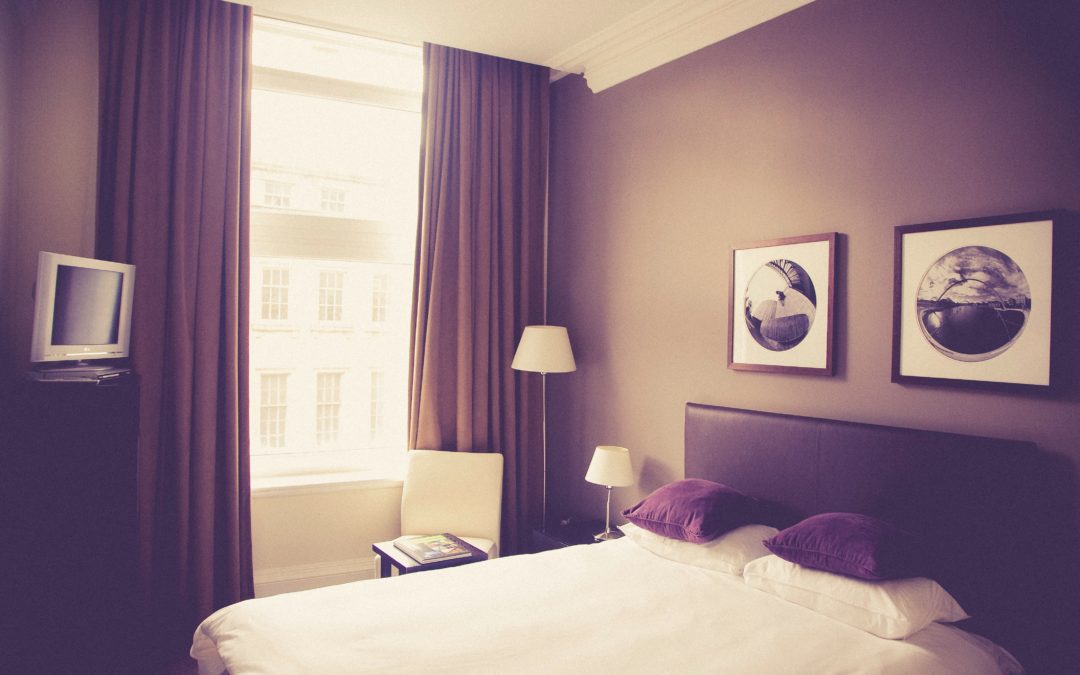 image of a hotel room bed and window